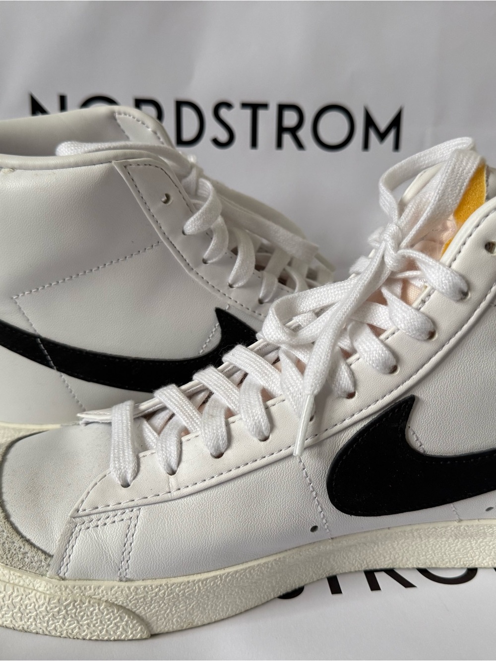 Nike Women's White High-Top Sneakers with Black Swoosh and Yellow Tongue Accent